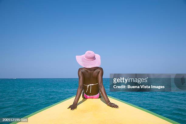woman sitting on boat's prow, rear view - jamaica bildbanksfoton och bilder