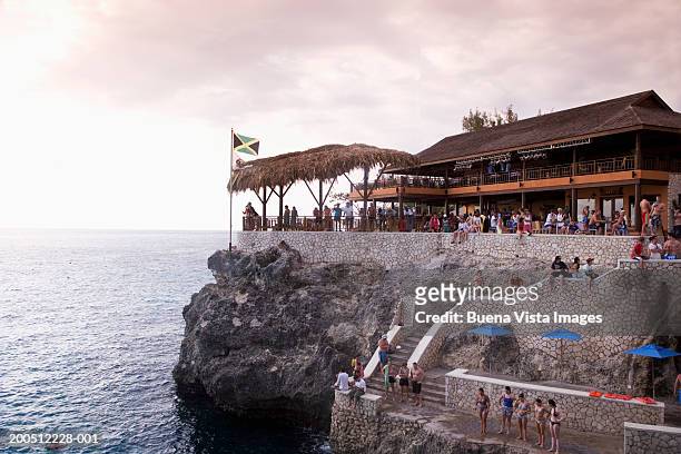 jamaica, negril, people at clifftop cafe, sunset - negril jamaica imagens e fotografias de stock