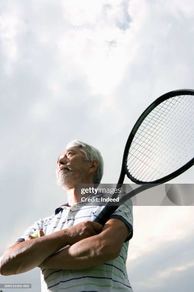 Man Using Tennis Racket Senior Man Holding Tennis Racquet Arms Folded Low Angle View High-Res ...