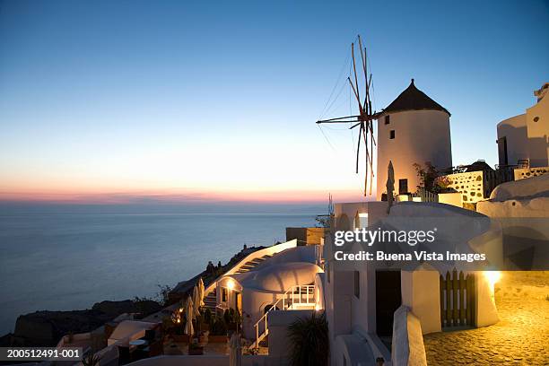 greece, cyclades, santorini, oia, street and windmill, dusk - pebbled road stock pictures, royalty-free photos & images