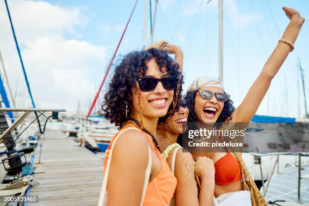 three girlfriends heading out on a sailing adventure - summer heading stock pictures, royalty-free photos & images