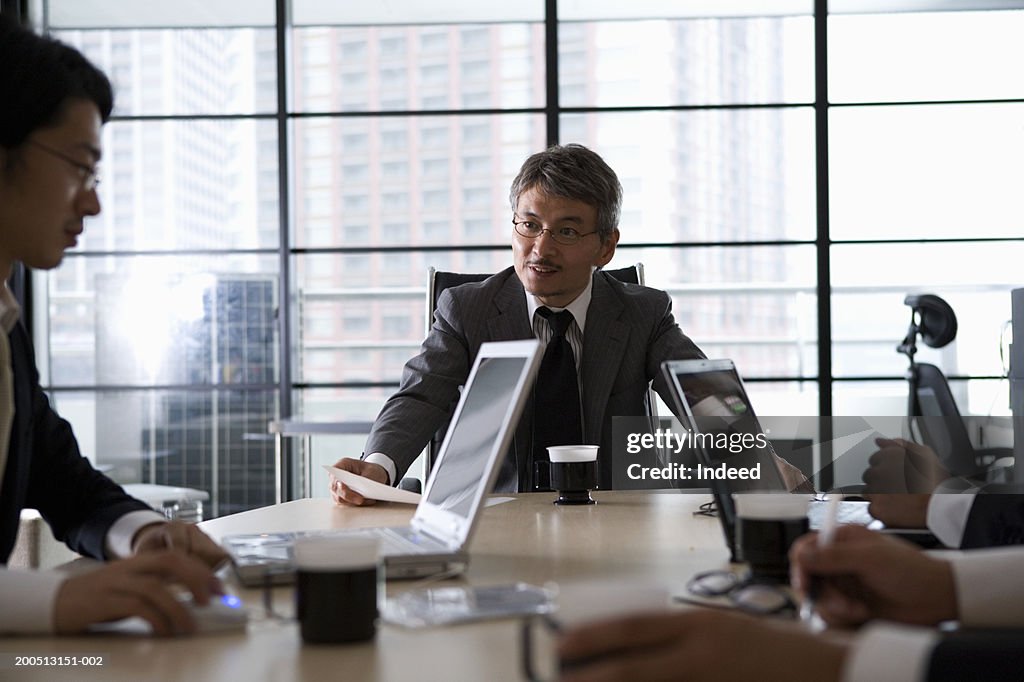 Four businessmen having meeting in office