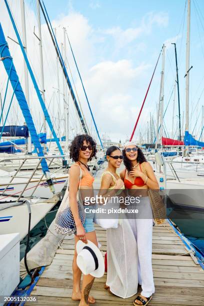 three girlfriends heading out on a sailing adventure - summer heading stock pictures, royalty-free photos & images