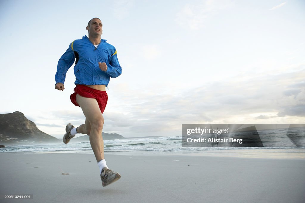 Man jogging along beach