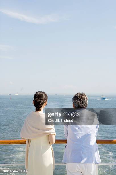 mature couple on deck of cruise ship, rear view - couple on cruise ship stock pictures, royalty-free photos & images