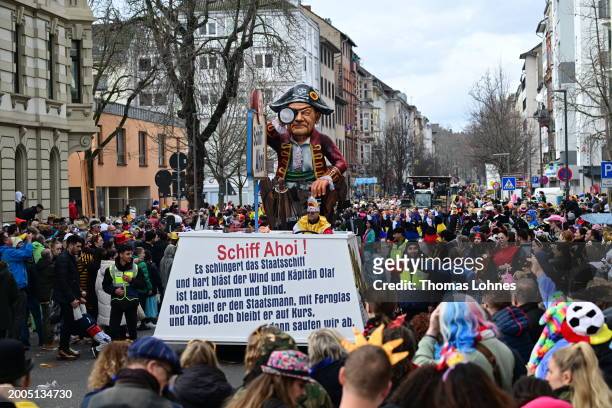 Parade float shows German Chancellor Olaf Scholz with eye patch in a sinking ship 'Ship Ahoy' at the annual Rose Monday Carnival parade on February...