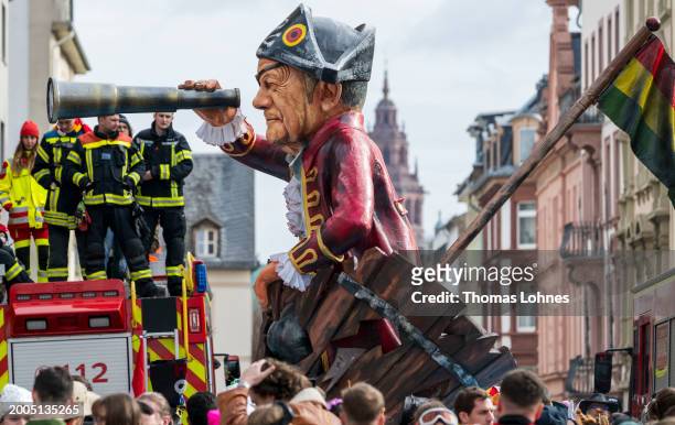Parade float shows German Chancellor Olaf Scholz with eye patch in a sinking ship 'Ship Ahoy' at the annual Rose Monday Carnival parade on February...
