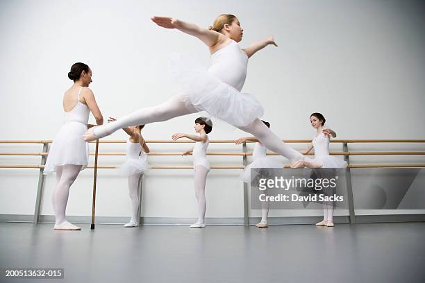 girl (8-10) performing grande jete in ballet class - preciseness stock pictures, royalty-free photos & images