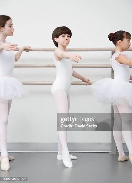 boy (12-14) practising at bar in ballet class, portrait - boy wearing dress photos et images de collection