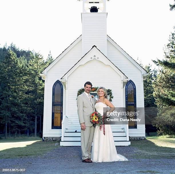 bride and groom standing outside chapel, portrait - 小教堂 個照片及圖片檔