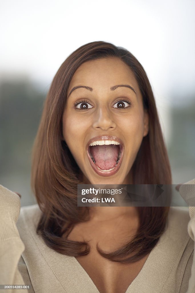 Young woman with mouth wide open, close-up, portrait