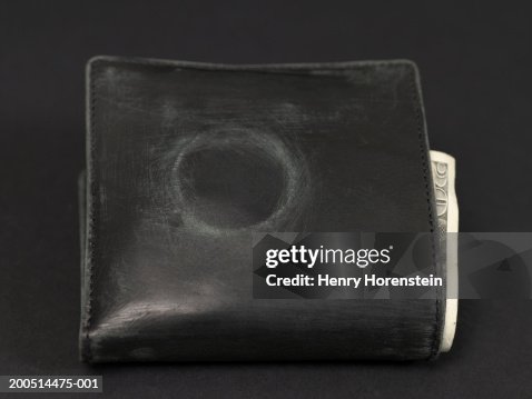 Worn wallet containing banknotes, showing evident condom mark Worn wallet containing banknotes, showing evident condom mark