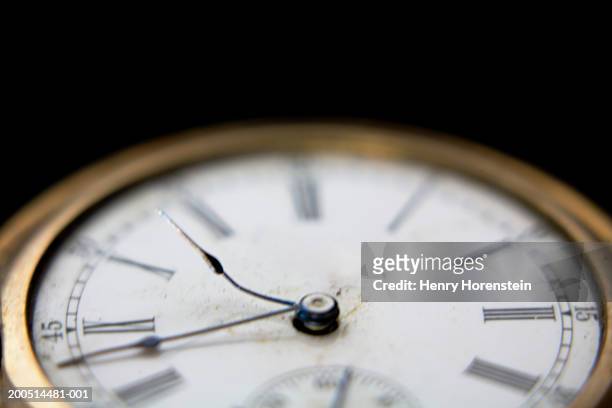 pocket watch with bent hands, focus on hands, close up - reloj antiguo fotografías e imágenes de stock