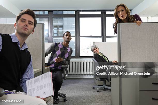 workers peeking from cubicles - office politics stockfoto's en -beelden