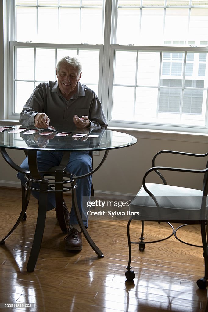 Man sitting playing cards