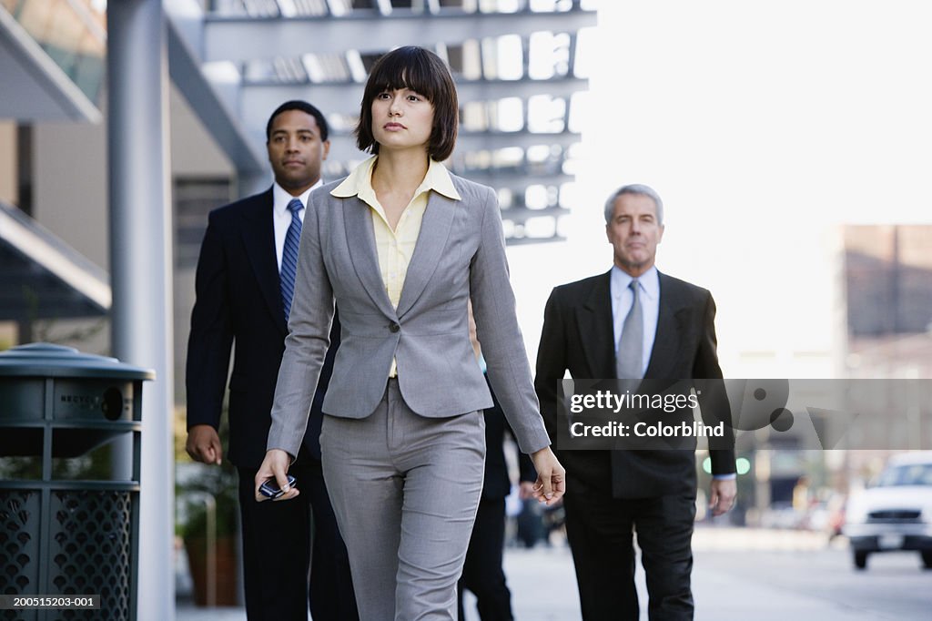 Business people walking in city street