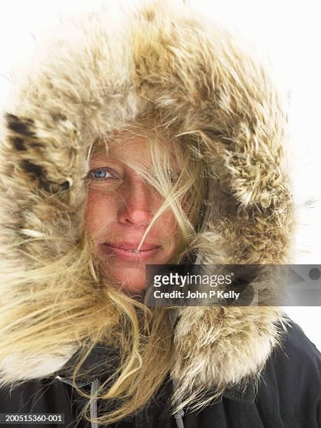 woman with fur-lined parka hood over head, portrait, close-up - parkas stockfoto's en -beelden