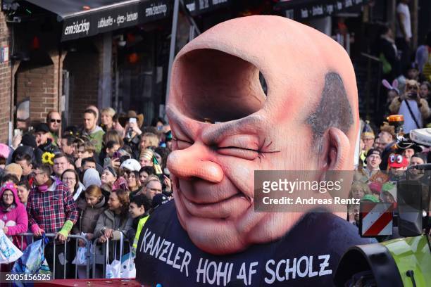 Parade float shows an effigy of German Chancellor Olaf Scholz at the annual Rose Monday Carnival parade on February 12, 2024 in Dusseldorf, Germany....