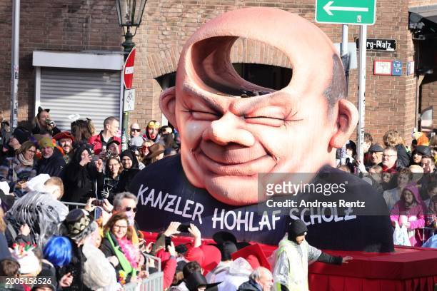 Parade float shows an effigy of German Chancellor Olaf Scholz at the annual Rose Monday Carnival parade on February 12, 2024 in Dusseldorf, Germany....