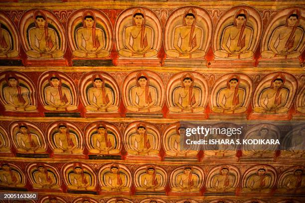 Painting of Buddha statues is seen on the ceiling of the Rangiri Dambulla Cave Temple in Dambulla, some 150 Km north of Sri Lanka's capital Colombo...