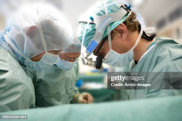 surgeons performing open heart surgery, close-up - open heart surgery foto e immagini stock