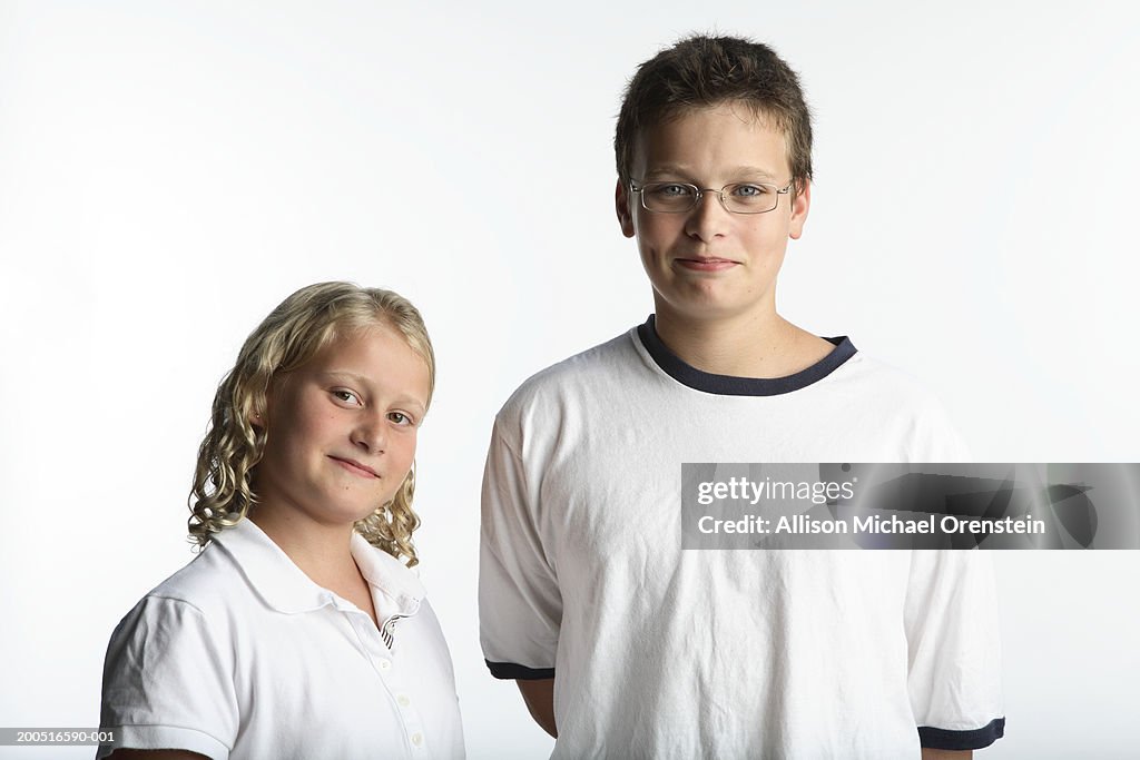 Brother and sister (8-11) smiling, portrait