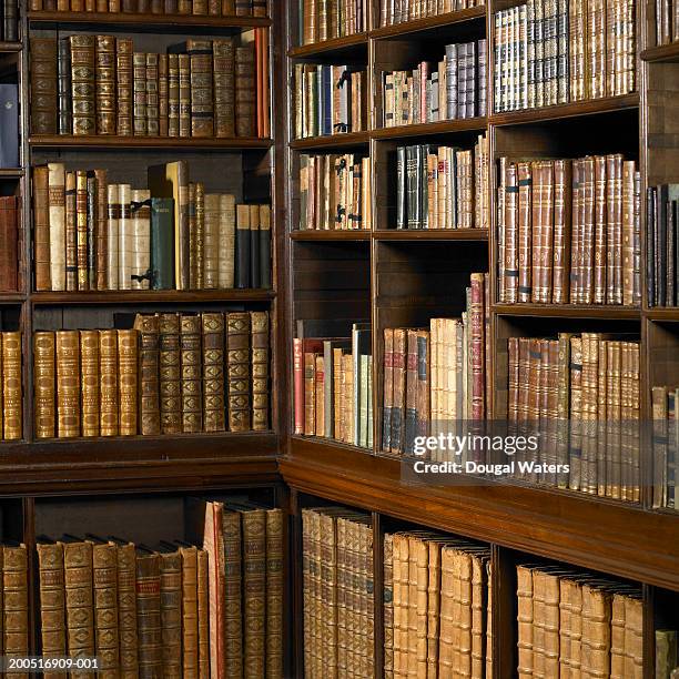 shelves of old books in library - hardbound stock pictures, royalty-free photos & images