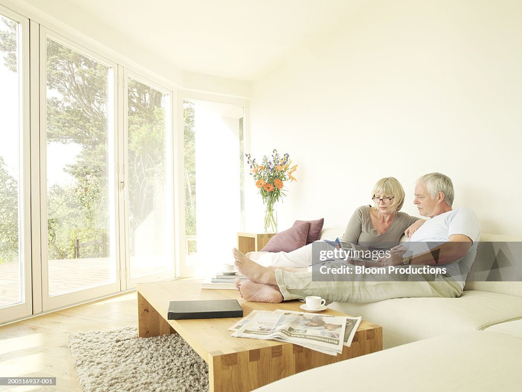 Mature couple reading on sofa