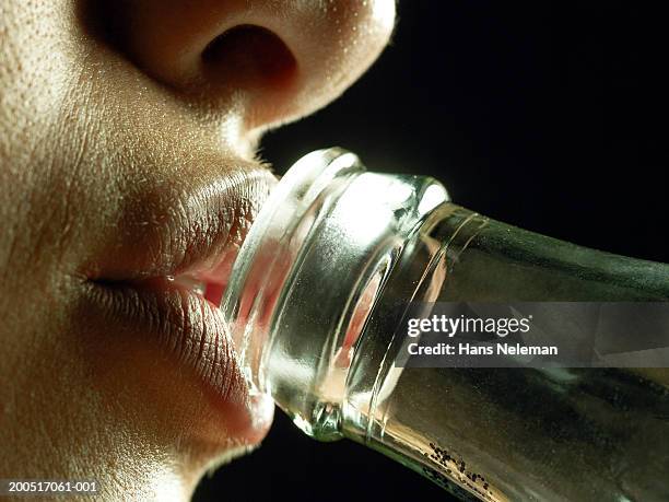 young woman sipping from glass bottle, close-up, profile - inside human mouth stock pictures, royalty-free photos & images