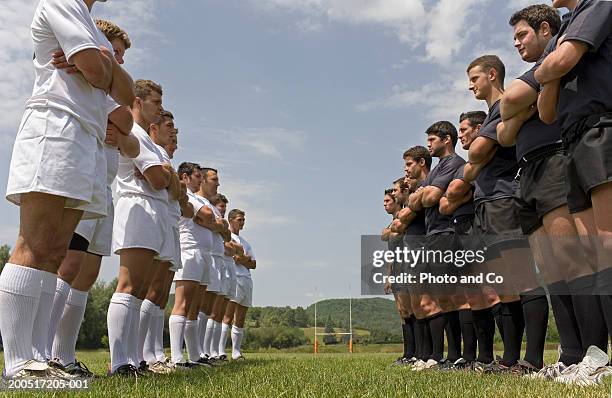 two rugby teams standing on pitch facing each other, low angle view - confrontation fotografías e imágenes de stock