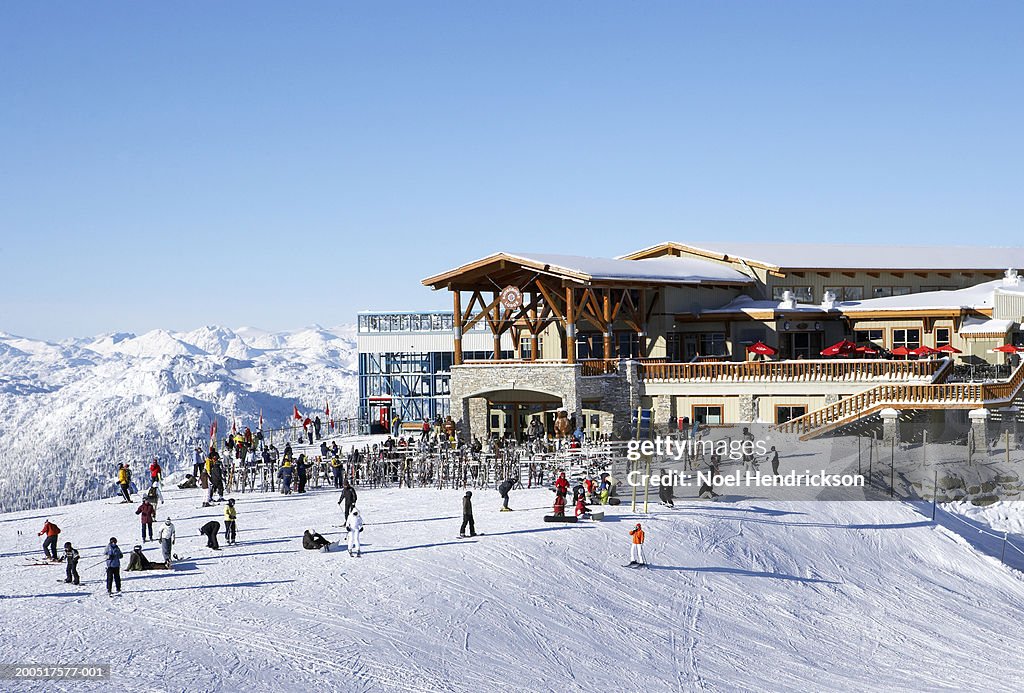 Canada, British Columbia, Whistler, people outside ski lodge