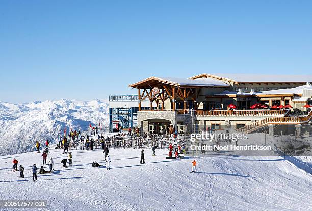 canada, british columbia, whistler, people outside ski lodge - whistler stockfoto's en -beelden