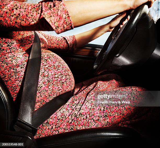 pregnant woman driving car, side view, mid-section, close-up - pregnant woman car stock pictures, royalty-free photos & images