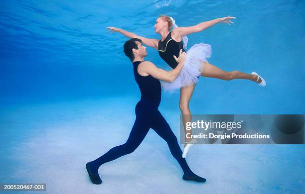 couple performing ballet in pool, underwater view - short dance stock pictures, royalty-free photos & images