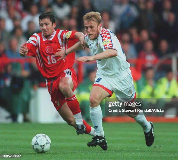 June 11: Sergen Yalcin of Turkey and Robert Prosinecki of Croatia challenge during the UEFA Euro 1996 Group D match between Turkey and Croatia at...