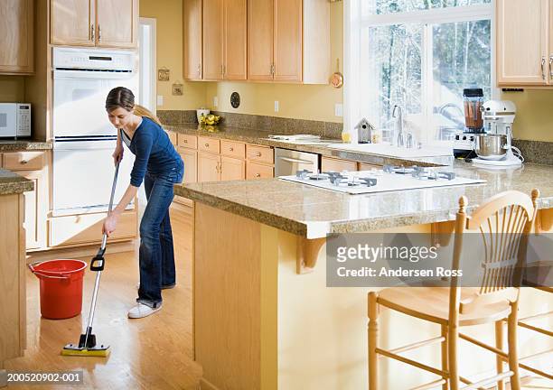 teenage girl (16-18) mopping kitchen floor - kitchen mop stock pictures, royalty-free photos & images