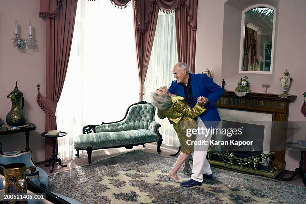 senior couple dancing in living room, elevated view - diva imagens e fotografias de stock