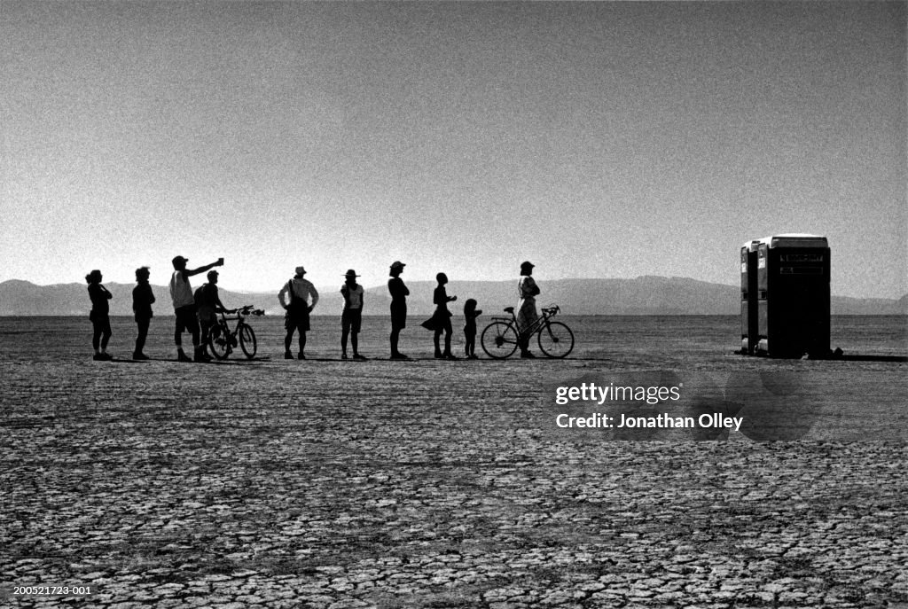 USA, Nevada, Black Rock Desert, festival goers queuing for lavatories