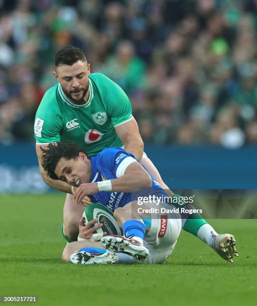 Ange Capuozzo of Italy is tackled by Robbie Henshaw during the Guinness Six Nations 2024 match between Ireland and Italy at Aviva Stadium on February...