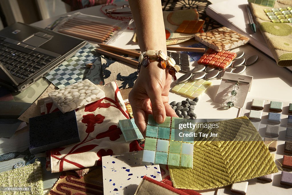 Woman picking out swatches from desk