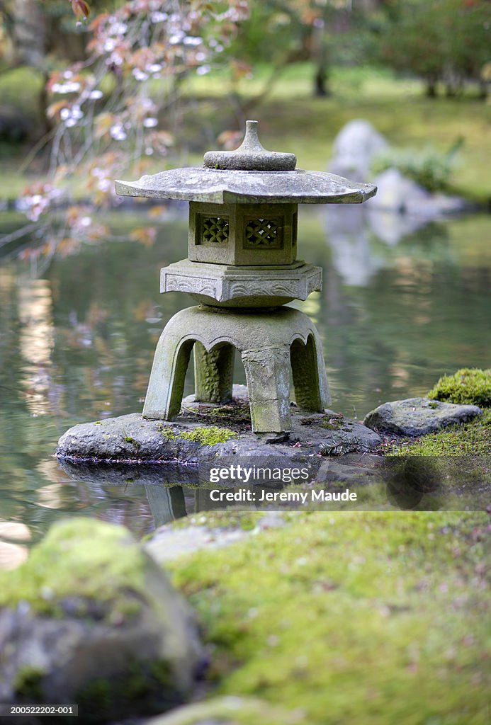 Ornamental stone pagoda in garden pond
