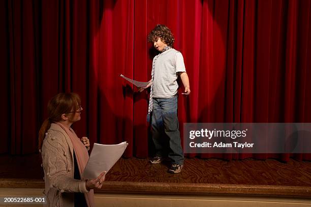 female teacher and boy (10-12) standing on stage rehearsing - acting stock pictures, royalty-free photos & images