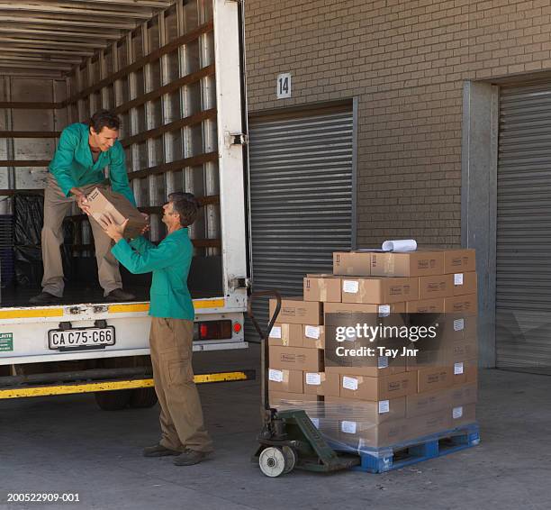 Two People Loading 606 Loading Boxes Into Truck Stock Photos, High-Res Pictures, and ...