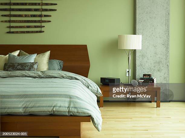 bed and night table in bedroom - bedding stock pictures, royalty-free photos & images