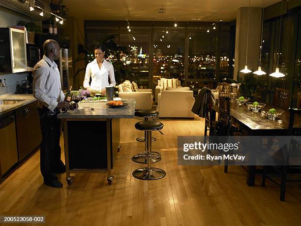 young man and woman standing in kitchen, man pouring wine, night - alcohol top view bildbanksfoton och bilder