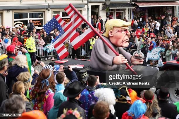 Parade float shows an effigy of Donald Trump holding a pair of scissors in his hand with a cut-up US flag in the shape of a swastika at the annual...
