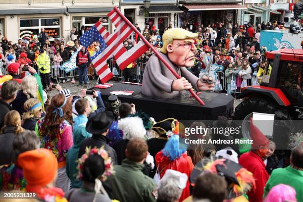 Parade float shows an effigy of Donald Trump holding a pair of scissors in his hand with a cut-up US flag in the shape of a swastika at the annual...