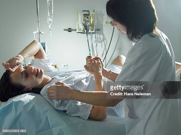 midwife supporting woman during pregnancy in hospital - mid wife stock pictures, royalty-free photos & images