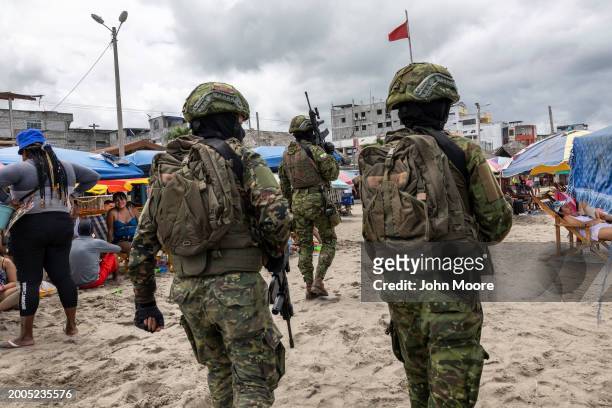 Soldiers patrol a beach during Carnival celebrations on February 11, 2024 in Atacames, Ecuador. Violent crime has dropped nationwide in the month...