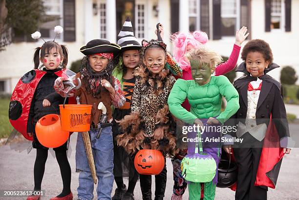 children (4-7) dressed up for halloween, group portrait - kids in halloween costumes stock pictures, royalty-free photos & images